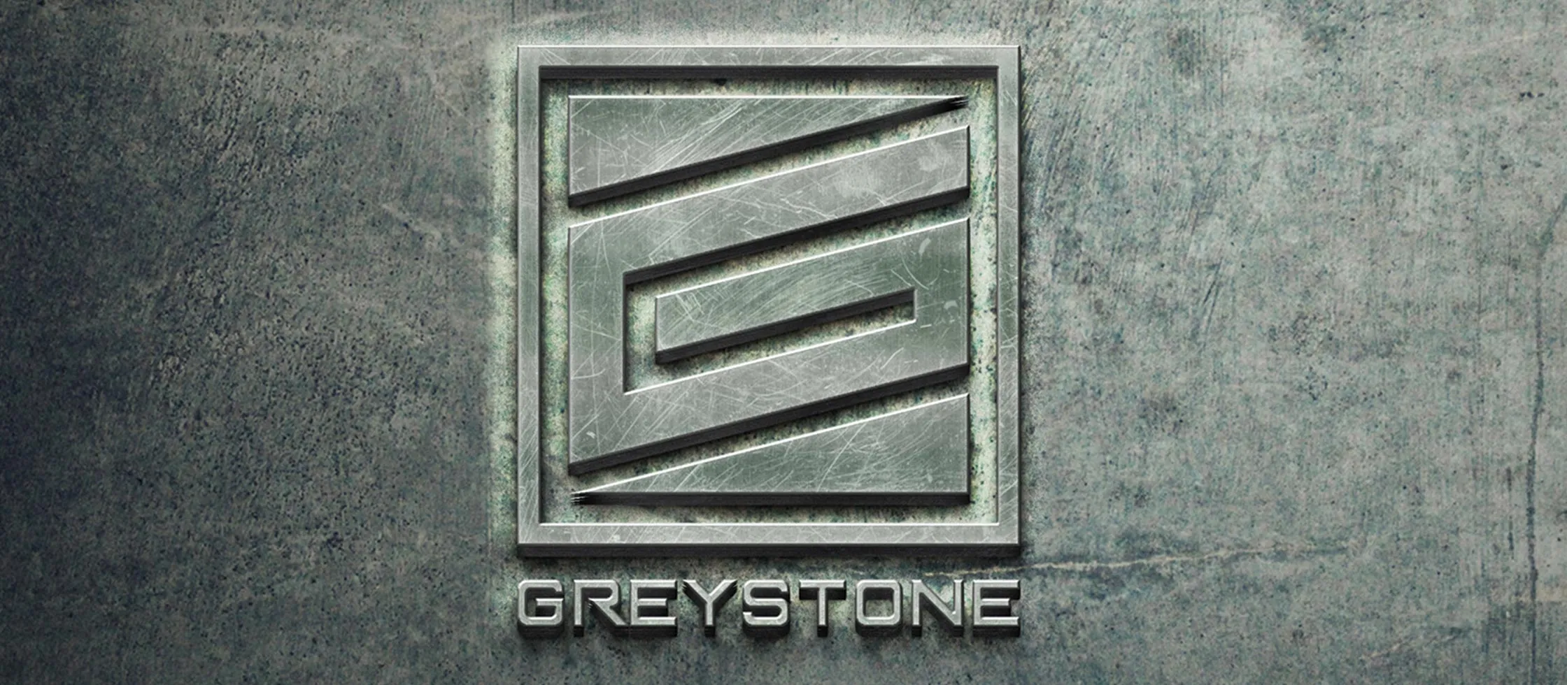 The Greystone logo: an angular mark inside a rectangular obelisk on a stone surface, with the GREYSTONE wordmark