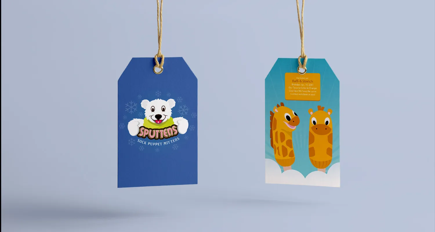 Two Sputtens hangtags on cords: one carrying the bear logo, one showing a pair of giraffe characters