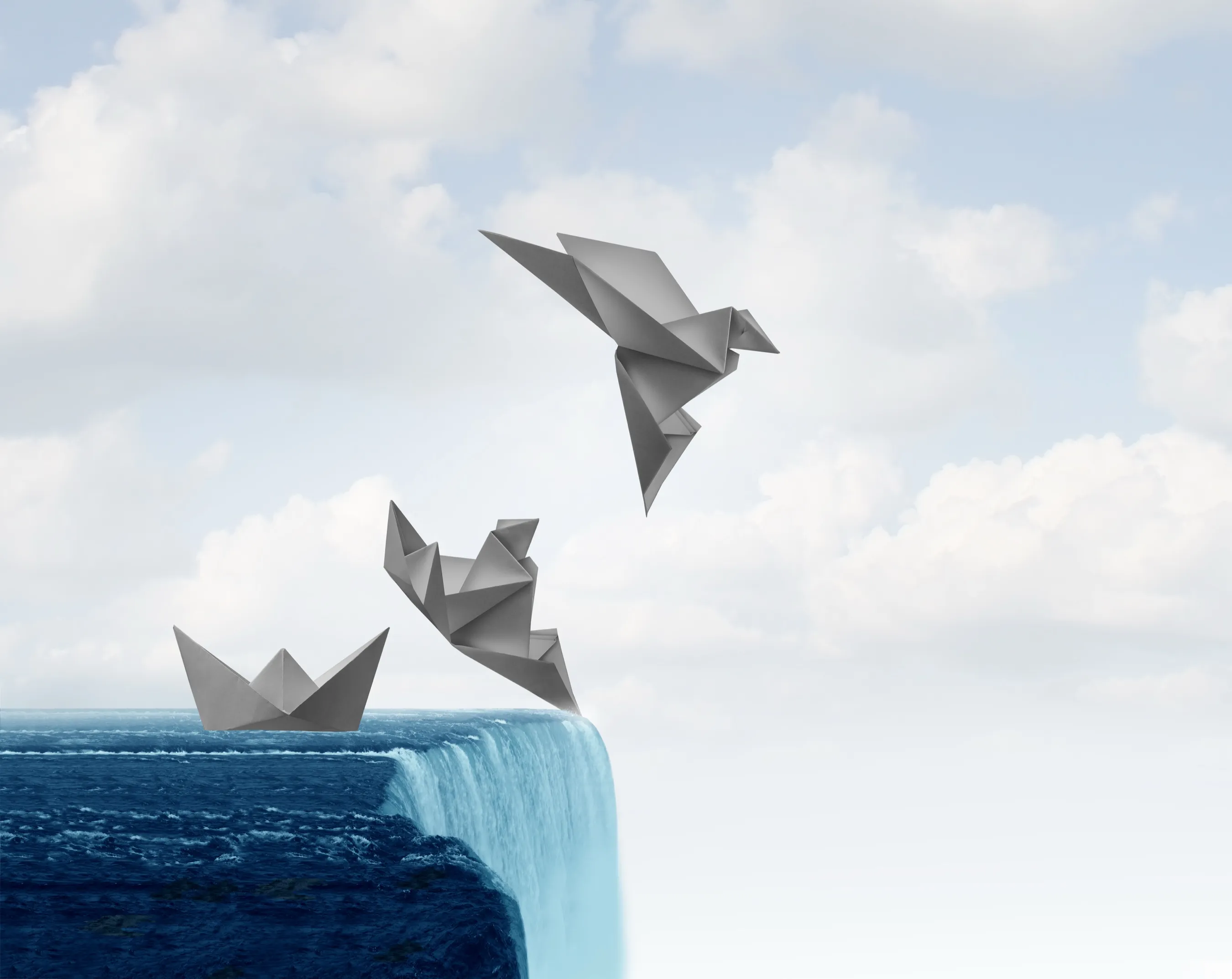 An origami paper boat at the edge of a waterfall transforming into a paper bird taking flight