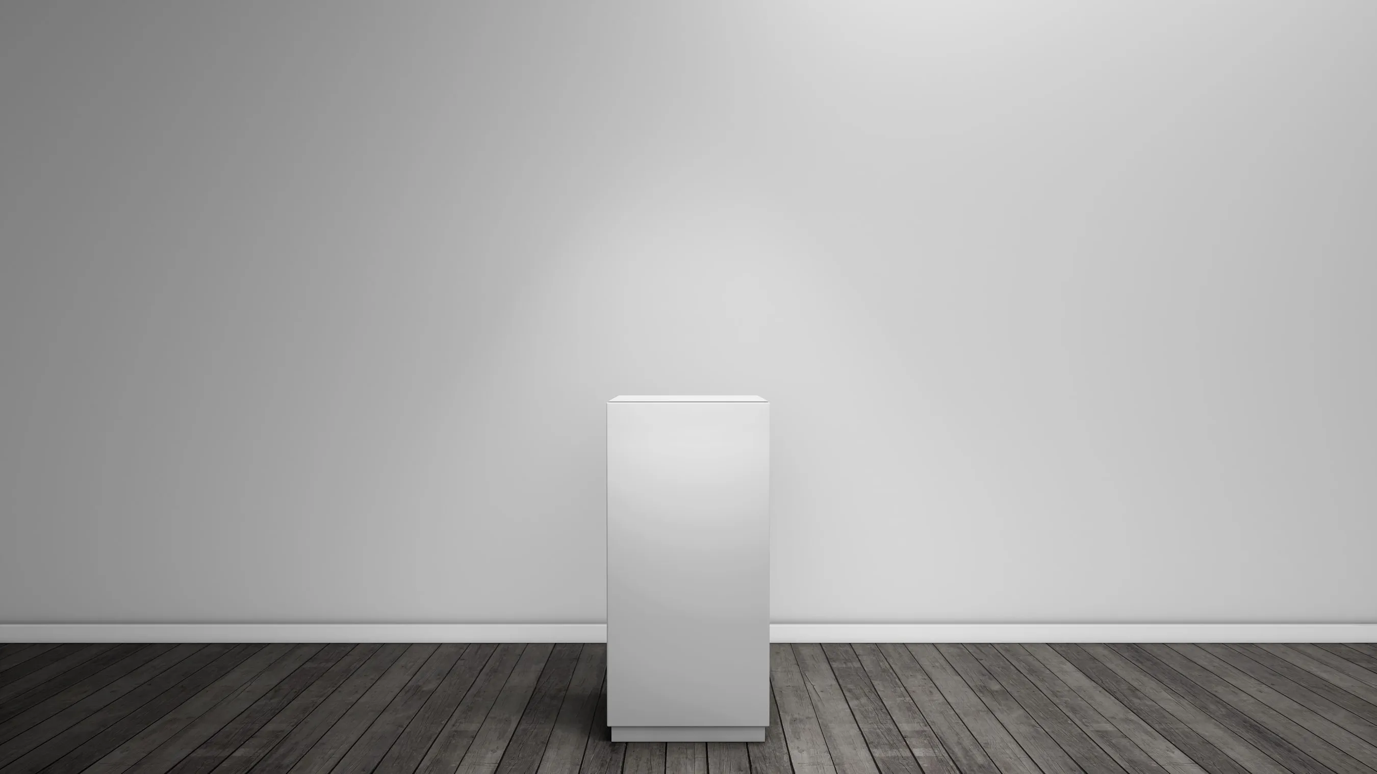 An empty white display pedestal on a dark wood floor against a lit gallery wall